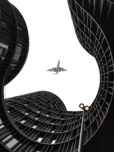 Futuristic architectural scene with airplane overhead, perfect for science fiction thriller book cover design