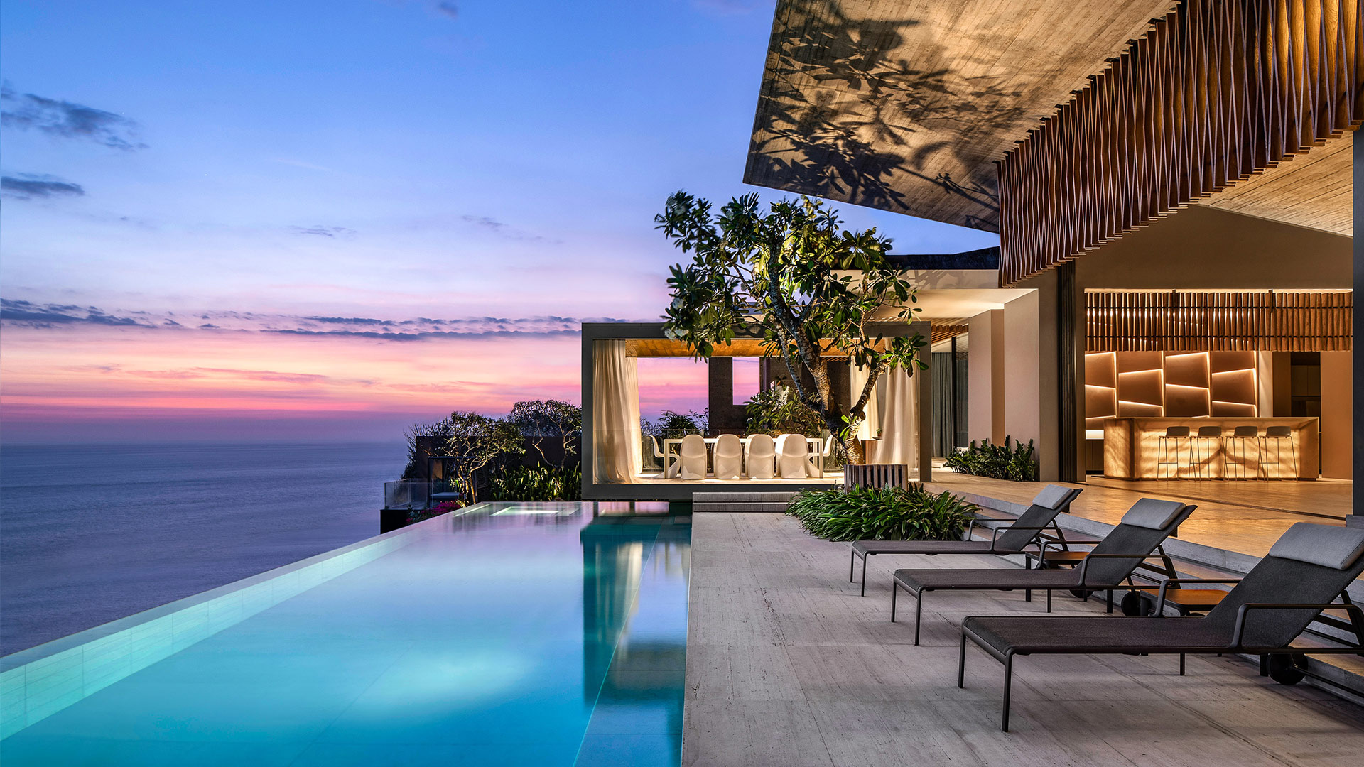 Luxury Bali villa with infinity pool overlooking ocean at sunset